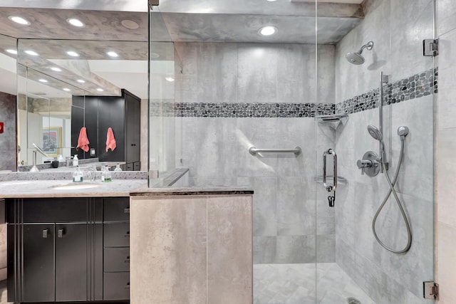 bathroom with vanity and a shower with door