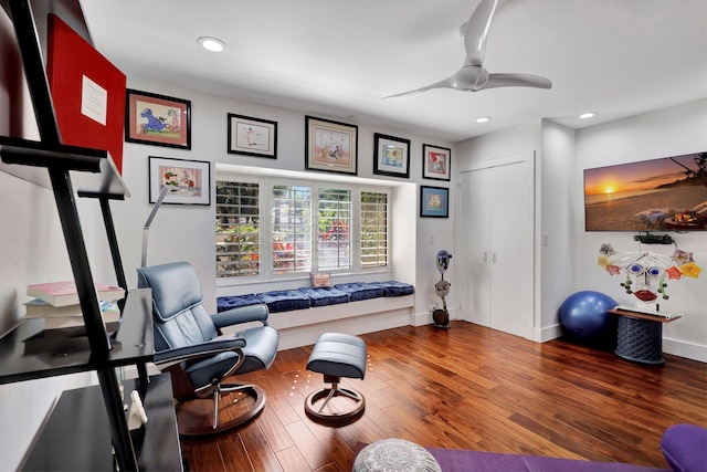 sitting room with hardwood / wood-style flooring and ceiling fan