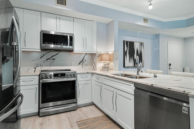 kitchen featuring white cabinetry and appliances with stainless steel finishes