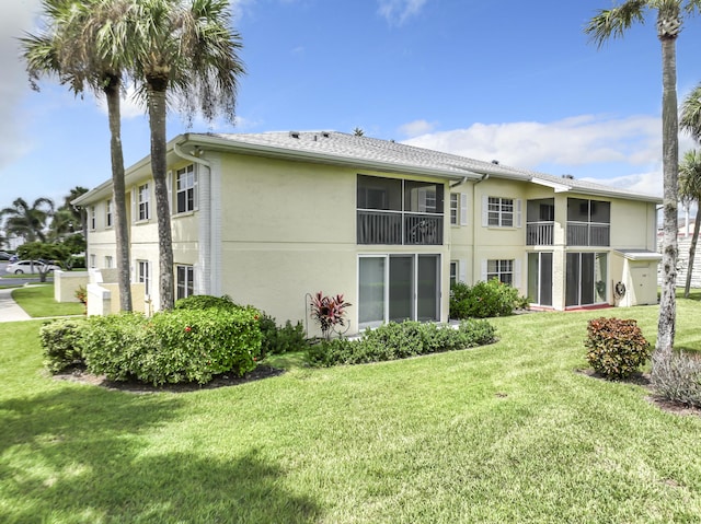 rear view of property featuring a yard