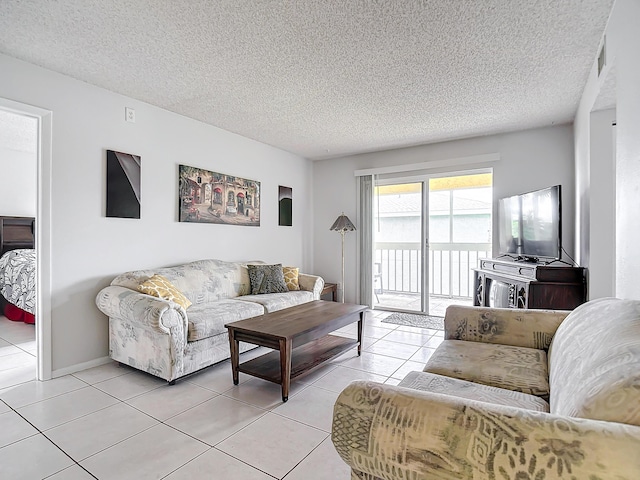 tiled living room featuring a textured ceiling