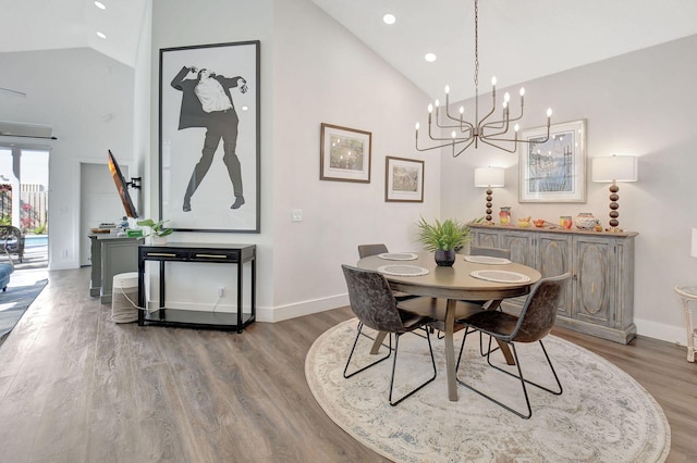 dining area featuring lofted ceiling and hardwood / wood-style floors