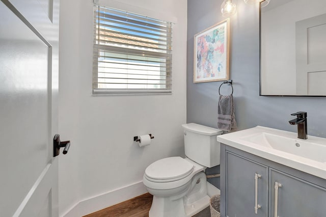 bathroom with vanity, hardwood / wood-style floors, and toilet