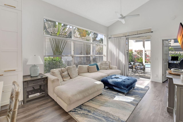 living room featuring vaulted ceiling, dark hardwood / wood-style floors, and ceiling fan