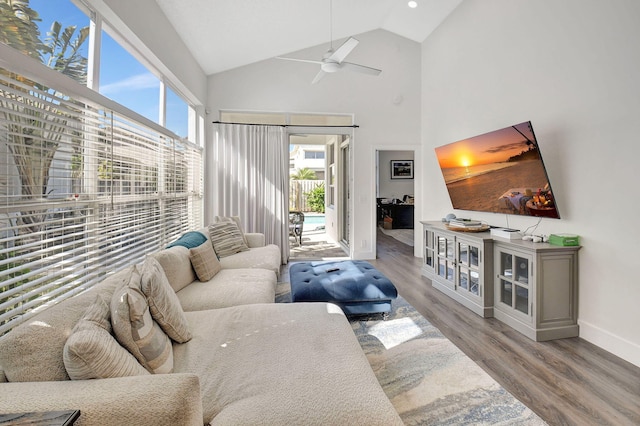 living room featuring vaulted ceiling, ceiling fan, and hardwood / wood-style floors