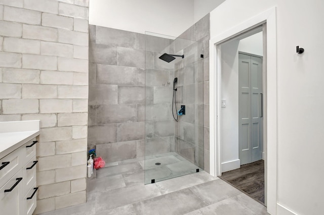 bathroom with vanity and a tile shower