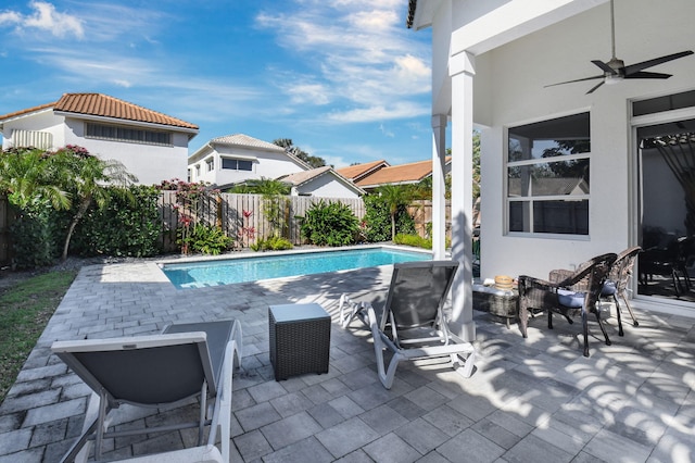 view of swimming pool featuring a patio and ceiling fan