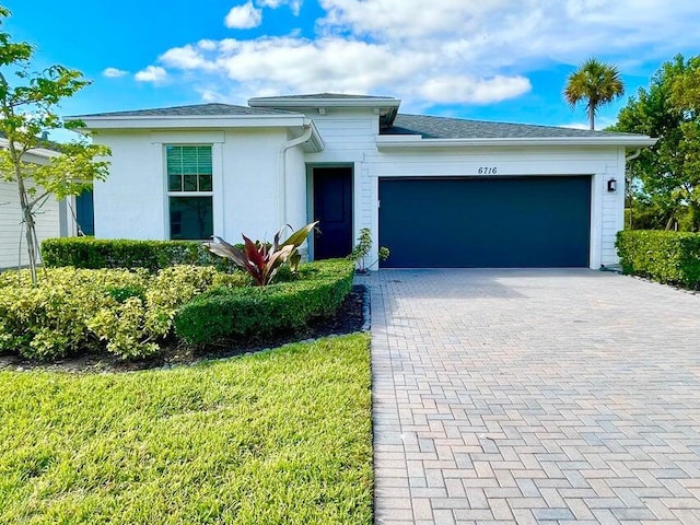 6716 Pointe Of Woods Dr, West Palm Beach, FL 33413 - view of front of home featuring decorative driveway and a garage