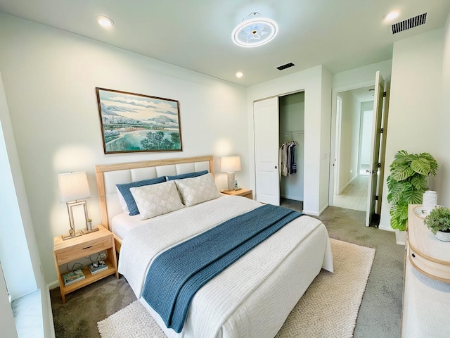 bedroom with dark carpet and a closet