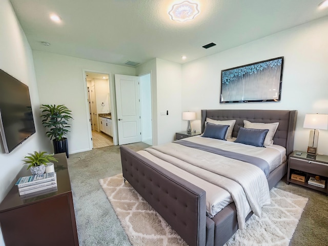 bedroom featuring recessed lighting, carpet, visible vents, and ensuite bathroom