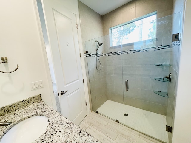 full bath featuring vanity and a shower stall