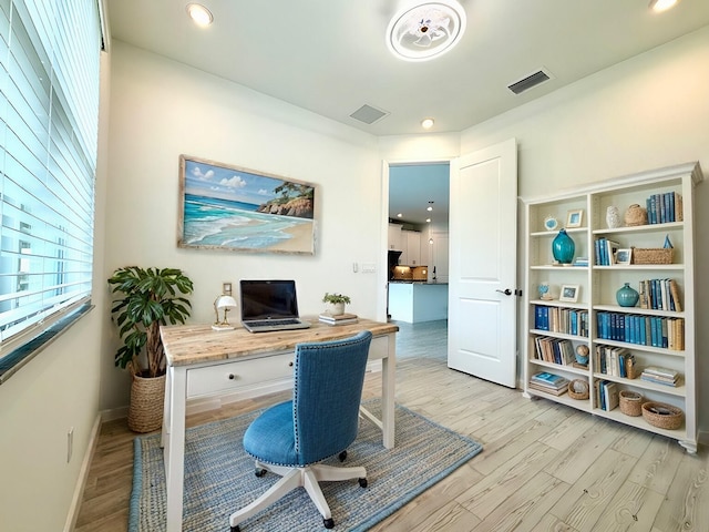 office space with light wood-type flooring