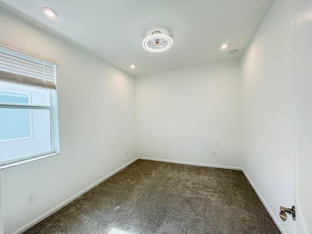 carpeted empty room featuring recessed lighting and baseboards