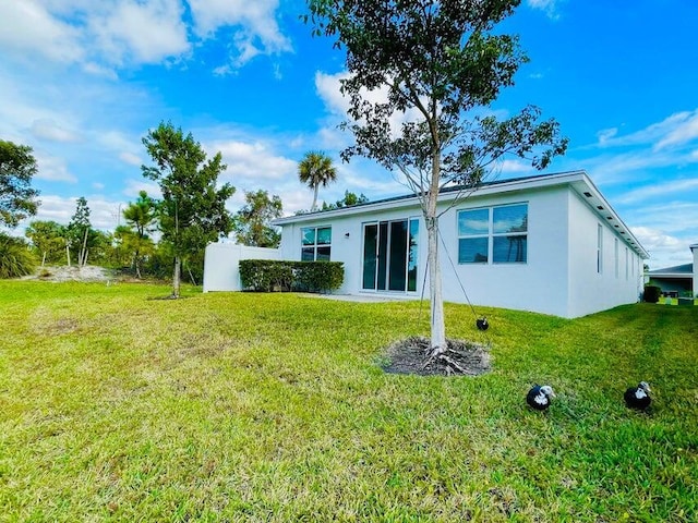 rear view of house with a lawn