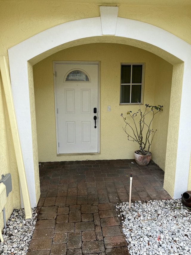 property entrance with stucco siding