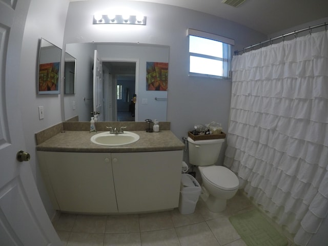 bathroom featuring visible vents, a shower with shower curtain, toilet, tile patterned floors, and vanity