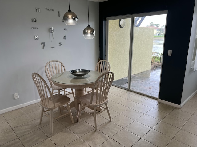 dining area featuring light tile patterned flooring and baseboards