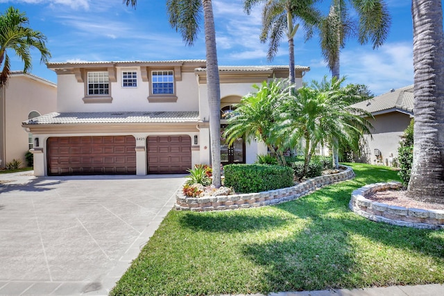 mediterranean / spanish-style house with an attached garage, driveway, a tiled roof, stucco siding, and a front yard