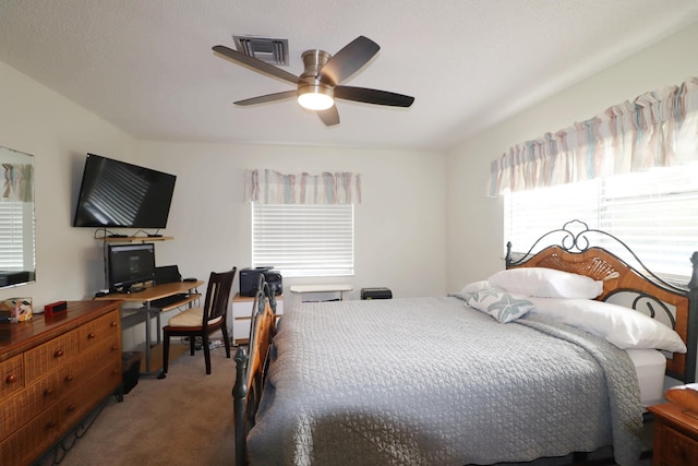 carpeted bedroom with multiple windows and ceiling fan