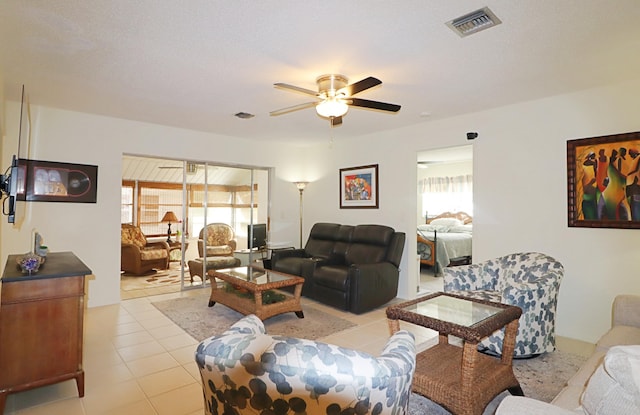 living room featuring ceiling fan, plenty of natural light, and light tile patterned floors