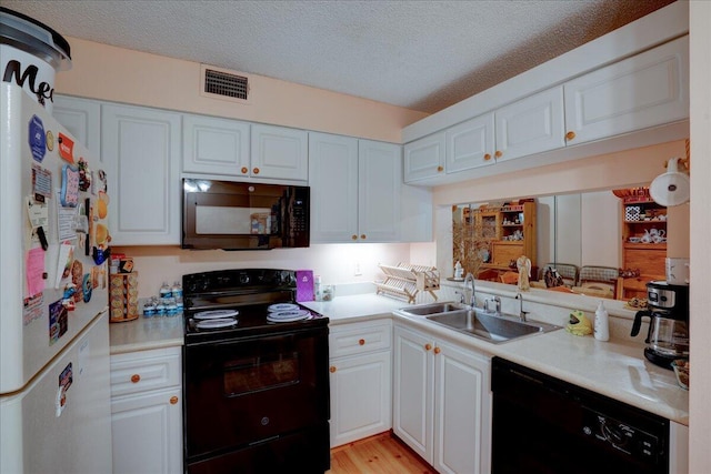 kitchen with white cabinetry, sink, a textured ceiling, and black appliances