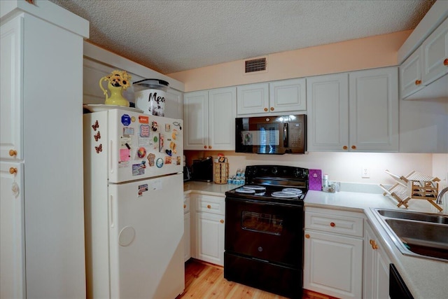 kitchen with sink, white cabinetry, light hardwood / wood-style flooring, a textured ceiling, and black appliances