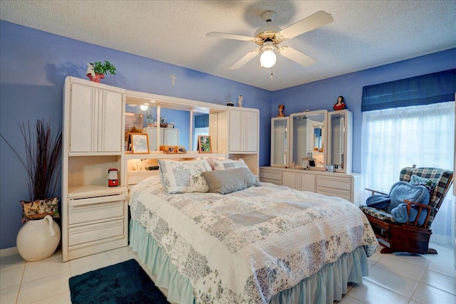 bedroom with light tile patterned floors, a textured ceiling, and ceiling fan