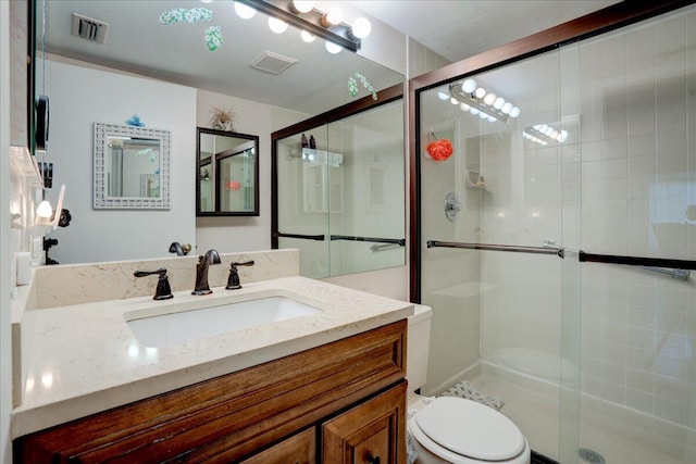 bathroom featuring walk in shower, vanity, and toilet