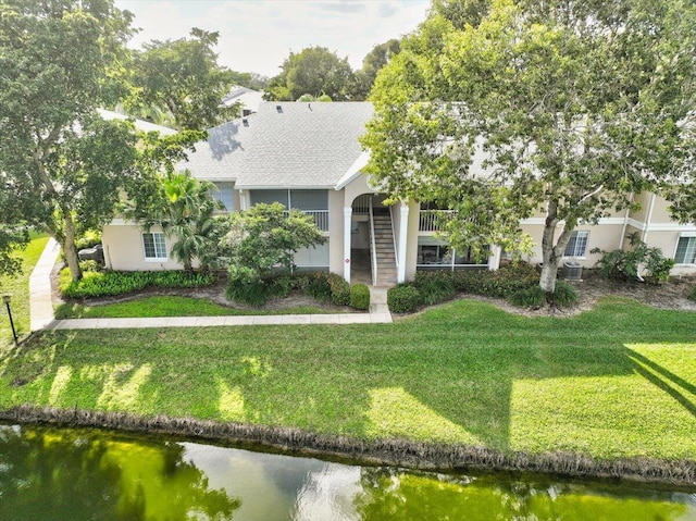 view of front of property with a water view and a front yard