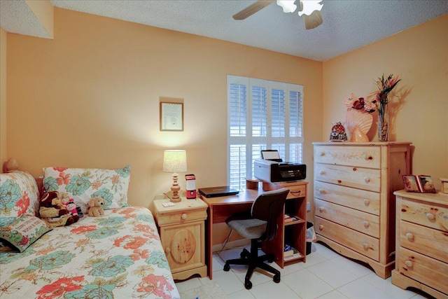 tiled bedroom with a textured ceiling and ceiling fan