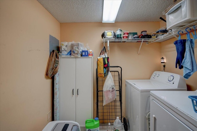 clothes washing area featuring washer and dryer and a textured ceiling