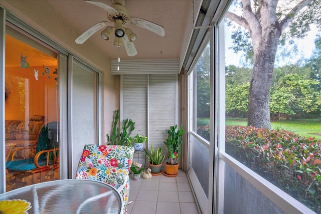 sunroom featuring ceiling fan