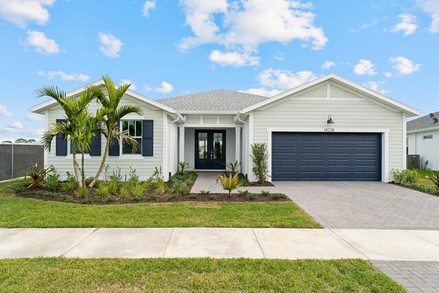 view of front facade with a garage and a front yard