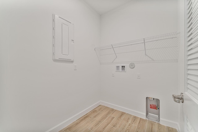 laundry room featuring hardwood / wood-style flooring, gas dryer hookup, hookup for a washing machine, and electric panel