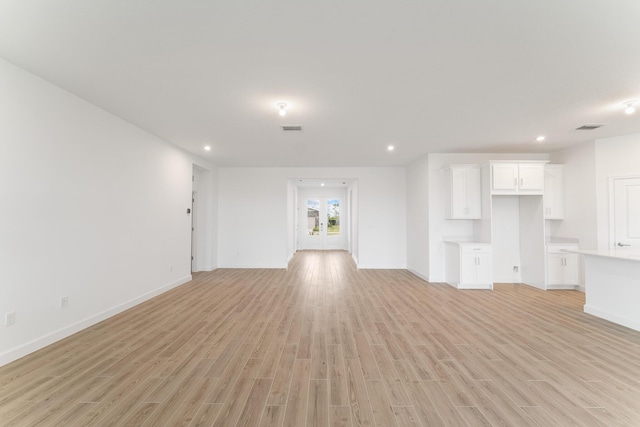 unfurnished living room featuring light wood-type flooring