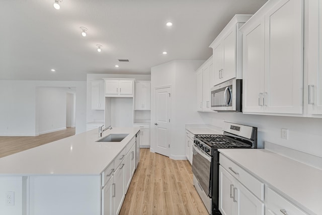 kitchen featuring white cabinetry, appliances with stainless steel finishes, and sink