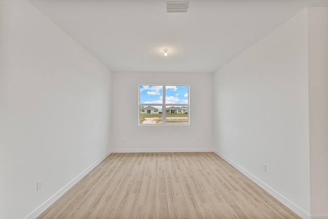 empty room with light hardwood / wood-style floors