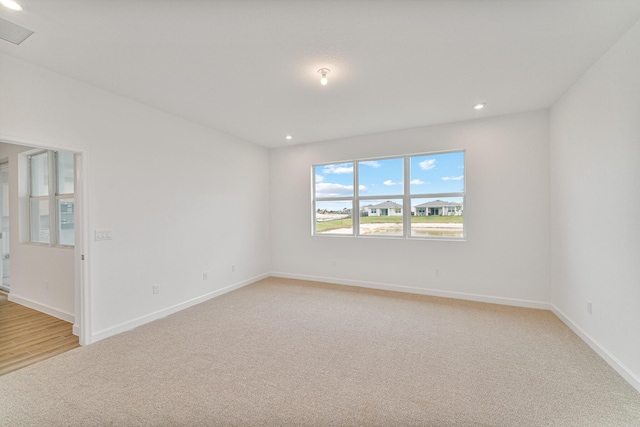 empty room featuring light colored carpet