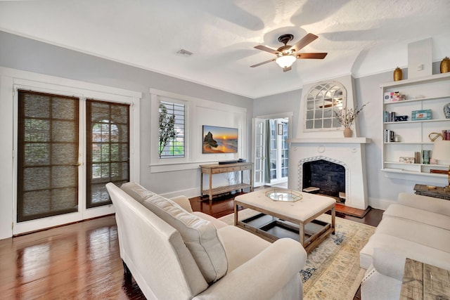 living room featuring dark hardwood / wood-style flooring, a textured ceiling, and ceiling fan