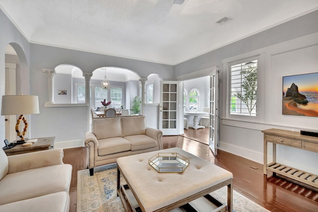 living room featuring hardwood / wood-style flooring and decorative columns