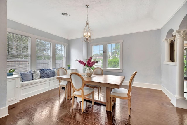 dining space featuring a notable chandelier, a wealth of natural light, and dark wood-type flooring