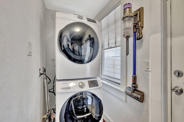 washroom with stacked washer / drying machine