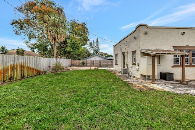 view of yard featuring central AC and a patio area