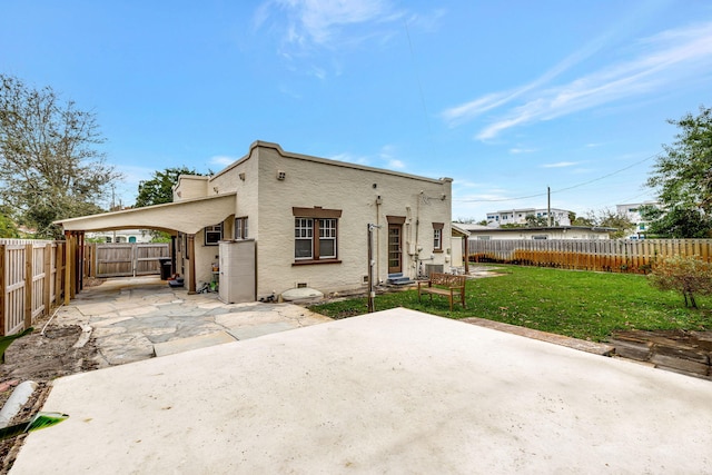 back of house with a yard and a patio area