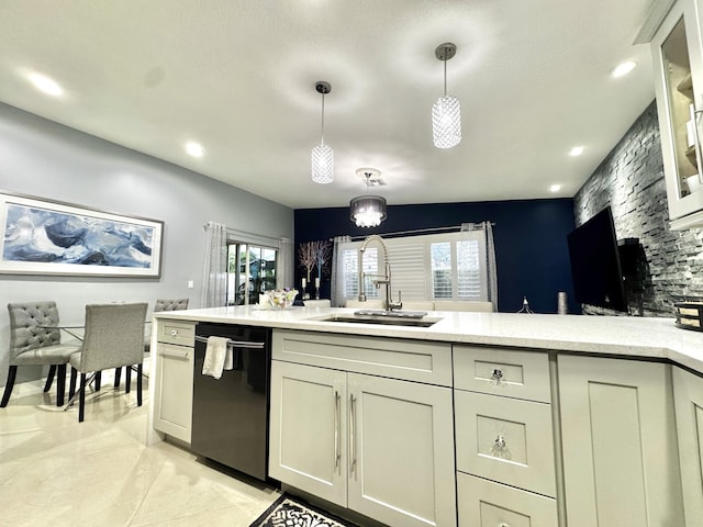 kitchen featuring sink, light tile patterned floors, black dishwasher, cream cabinets, and decorative light fixtures