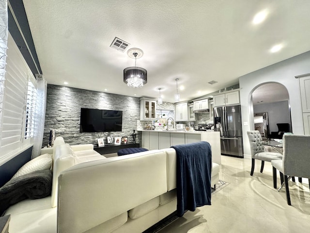 living room with sink and a textured ceiling