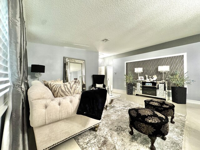 living room featuring concrete flooring and a textured ceiling