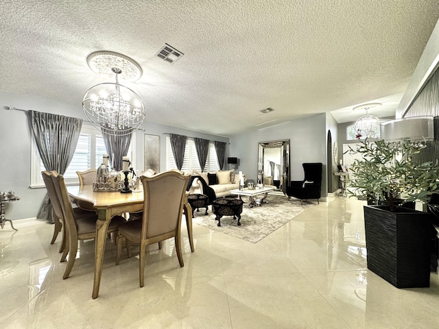 dining room featuring a chandelier and a textured ceiling