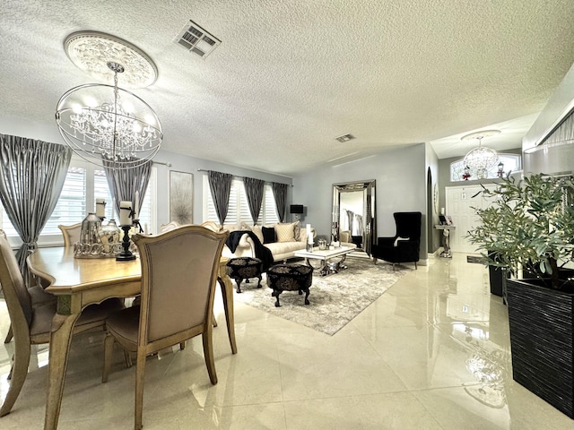 dining area with a healthy amount of sunlight, a chandelier, and a textured ceiling