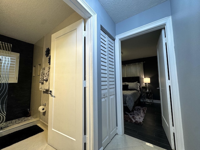 bathroom featuring tile patterned floors and a textured ceiling